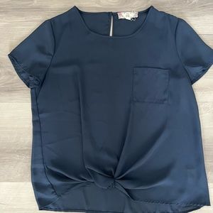 Sheer blouse with knot at bottom and pocket. Size M